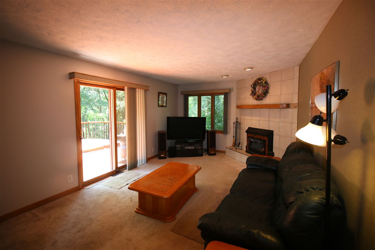 8163 McCurry Road Roscoe, IL 61073 - Photo 8 of 24 a living room with furniture and a fireplace