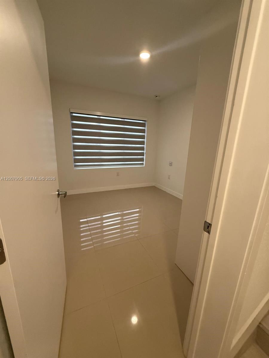 25664 Southwest 143rd Path, Unit 25664 Homestead, FL 33032 - Photo 4 of 17 a view of empty room with window