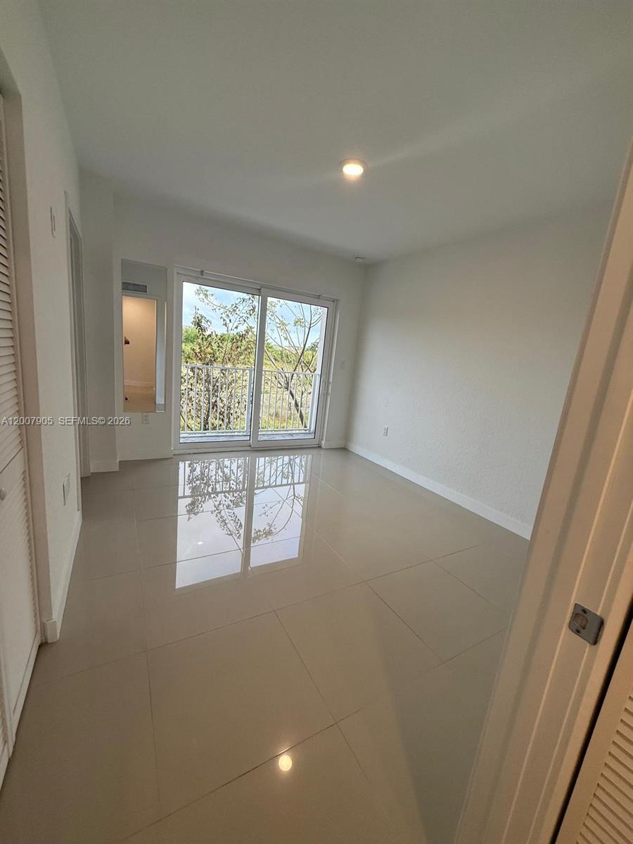 25664 Southwest 143rd Path, Unit 25664 Homestead, FL 33032 - Photo 7 of 17 an empty room with windows