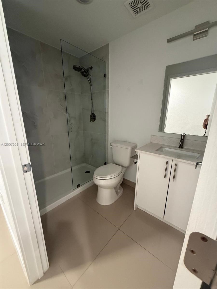 25664 Southwest 143rd Path, Unit 25664 Homestead, FL 33032 - Photo 8 of 17 a bathroom with a granite countertop sink toilet and shower