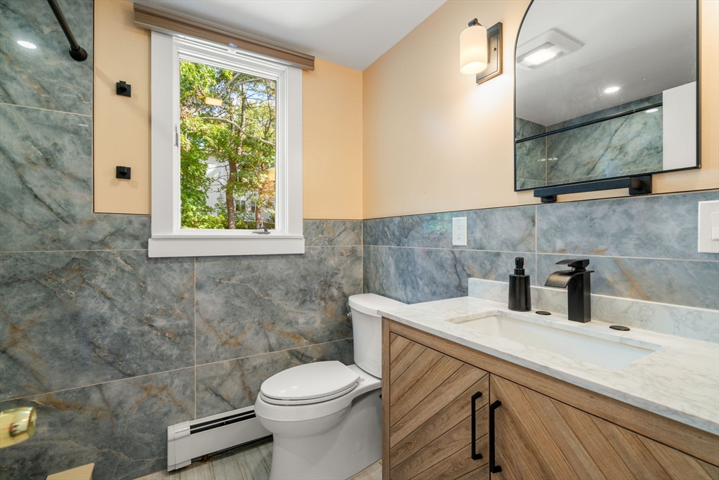 381 Main Street Saugus, MA 01906 - Photo 19 of 31 a bathroom with a sink a toilet and mirror