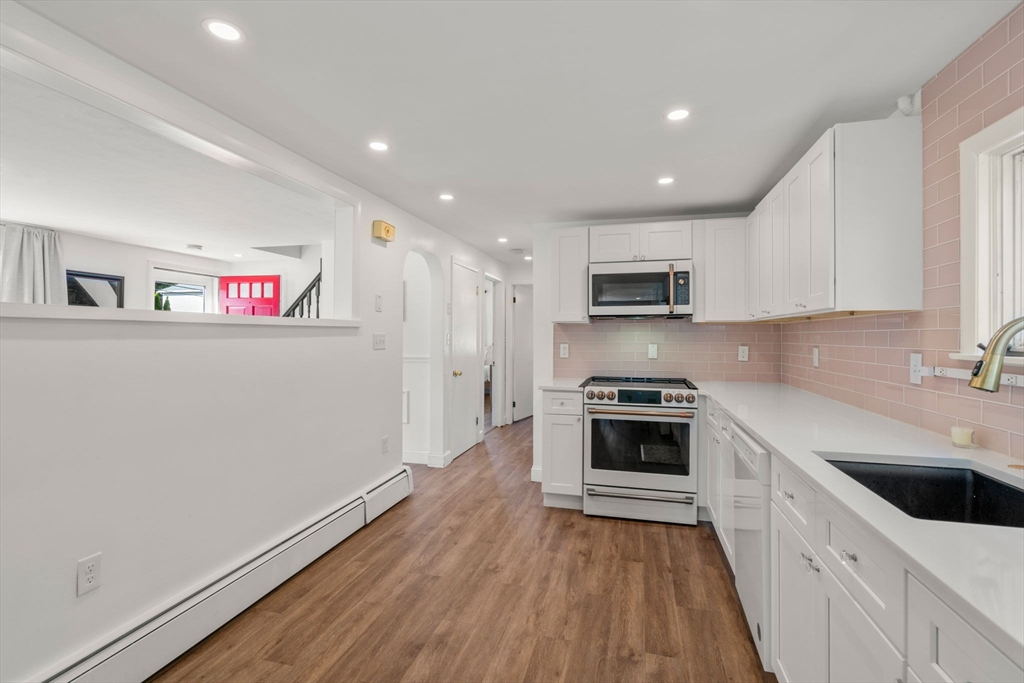 381 Main Street Saugus, MA 01906 - Photo 7 of 31 a kitchen with granite countertop a stove top oven and sink