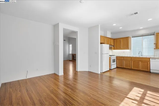 a view of a kitchen with wooden floor and a sink