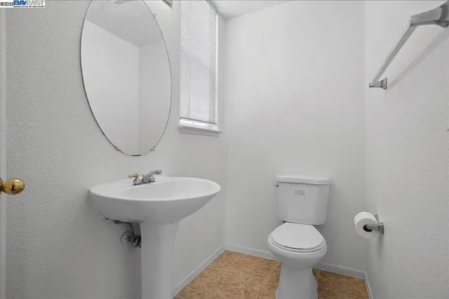 a bathroom with a sink toilet and a mirror