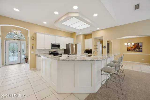 a spacious bathroom with a sink a large mirror and a shower