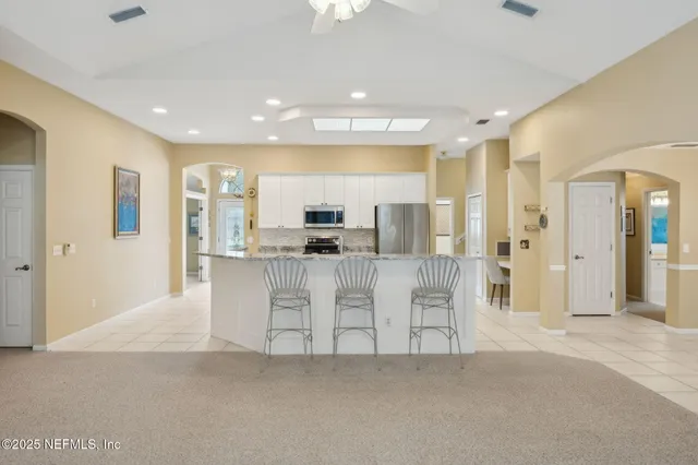 an aerial view of residential houses with outdoor space and trees