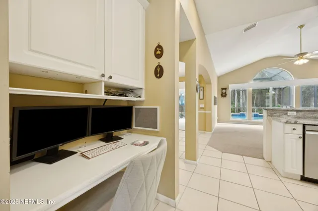 an aerial view of residential houses with outdoor space and trees