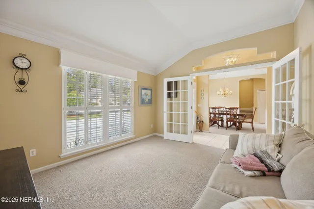 a view of a dining room with furniture and chandelier