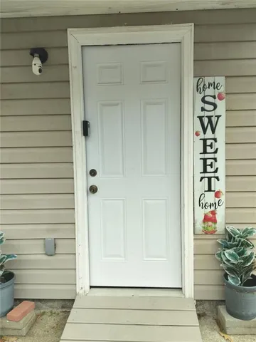 a view of front door and potted plants