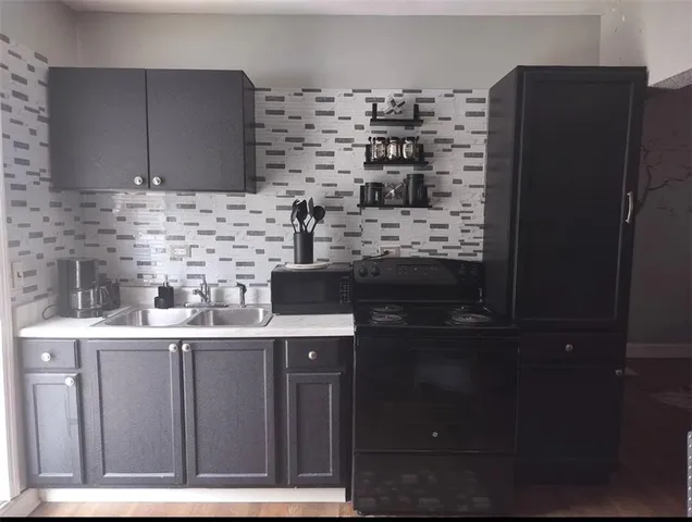 a kitchen with a stove and a refrigerator