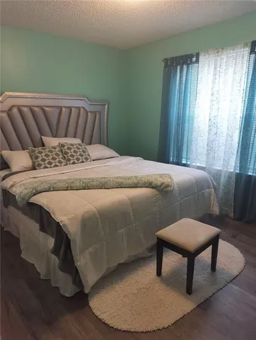 a bed sitting in a bedroom next to a window