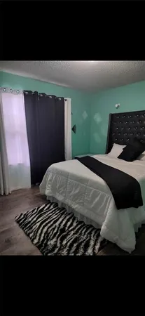 a bedroom with a bed and window