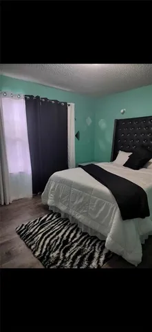 a bedroom with a bed and window