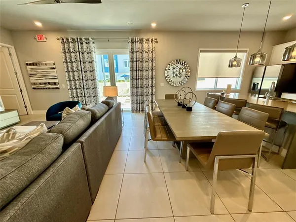 a dining room with furniture and a flat screen tv