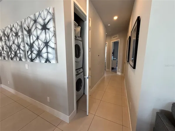 a bedroom with a bed and a flat tv screen on dresser