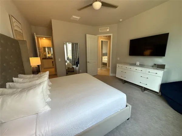 a bedroom with a bed dresser and a window