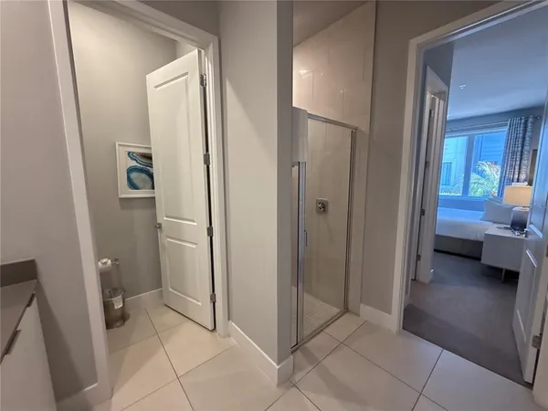 a spacious bathroom with a double vanity sink a mirror and a shower