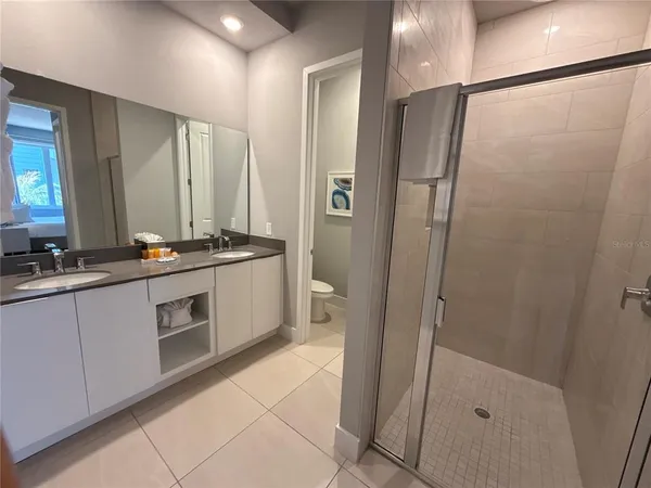 a spacious bathroom with a double vanity sink and a mirror