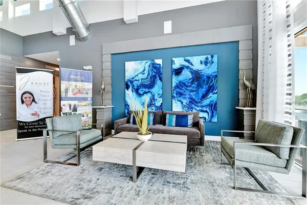 a kitchen with stainless steel appliances kitchen island granite countertop a table chairs sink and cabinets