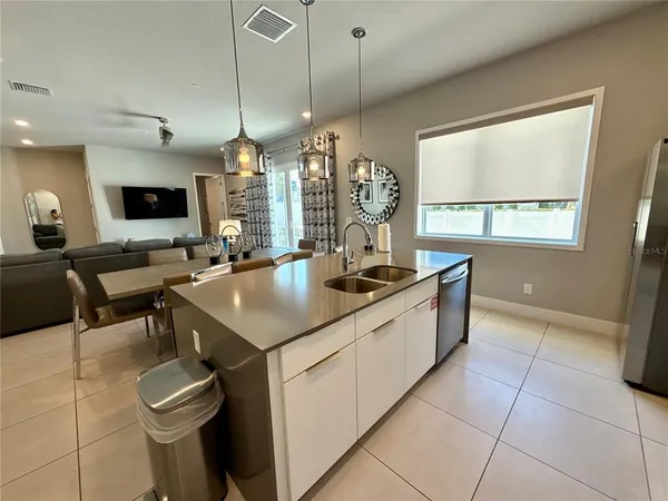 a kitchen with a sink a counter top space and a window