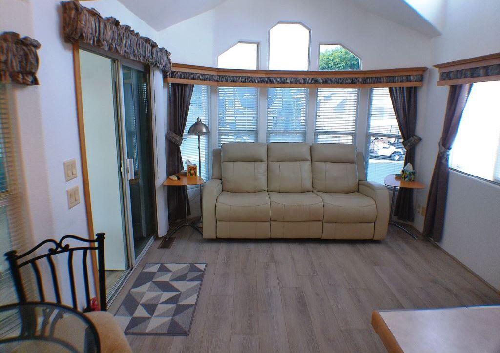 84136 Ave 44, Unit 150 Indio, CA 92203 - Photo 14 of 37 a living room with furniture and a floor to ceiling window