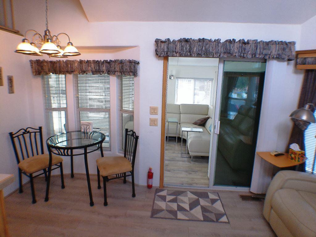 84136 Ave 44, Unit 150 Indio, CA 92203 - Photo 16 of 37 a living room with furniture and a chandelier