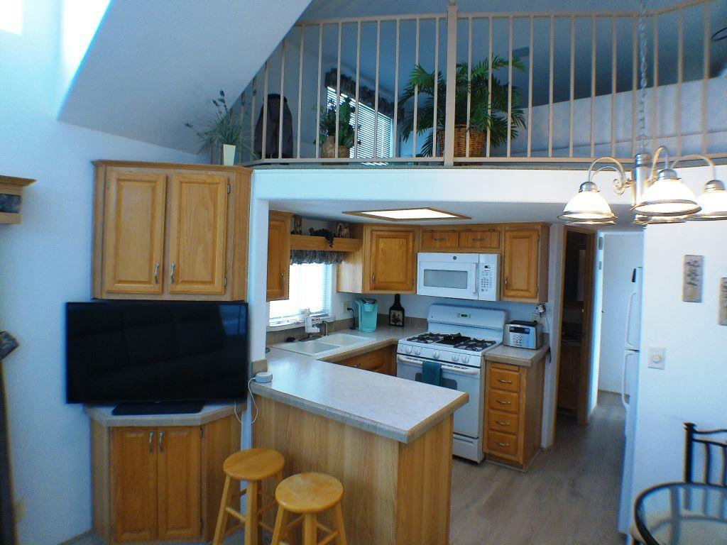 84136 Ave 44, Unit 150 Indio, CA 92203 - Photo 25 of 37 a kitchen with a sink a stove and a refrigerator