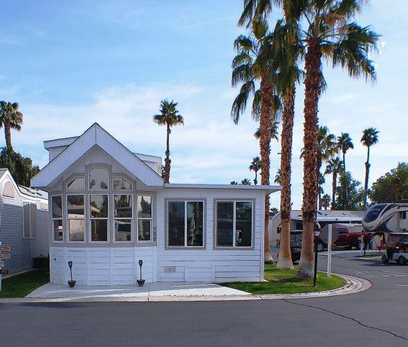 84136 Ave 44, Unit 150 Indio, CA 92203 - Photo 3 of 37 a front view of a house with a garden and tree