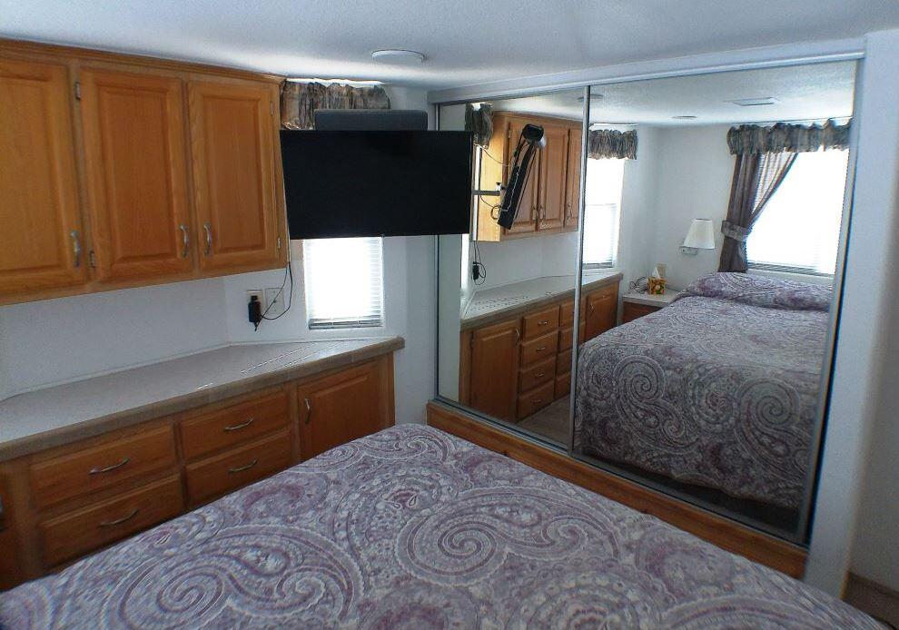 84136 Ave 44, Unit 150 Indio, CA 92203 - Photo 31 of 37 a bedroom with a bed and a dresser