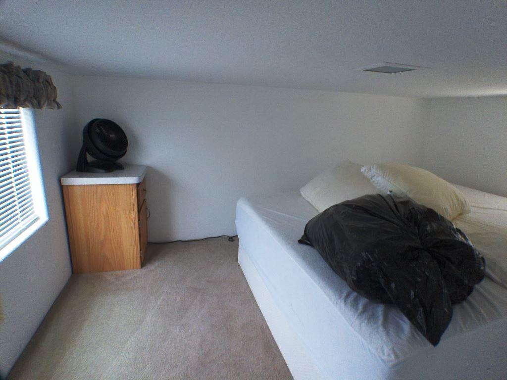 84136 Ave 44, Unit 150 Indio, CA 92203 - Photo 37 of 37 a bedroom with a bed and cabinets