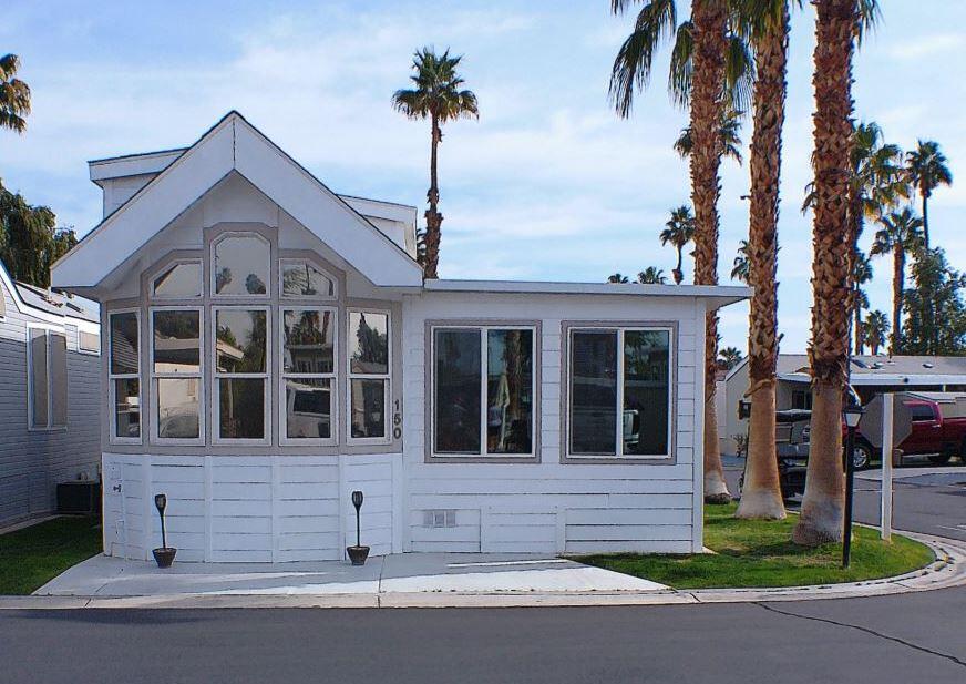 84136 Ave 44, Unit 150 Indio, CA 92203 - Photo 4 of 37 a front view of a house with a garden