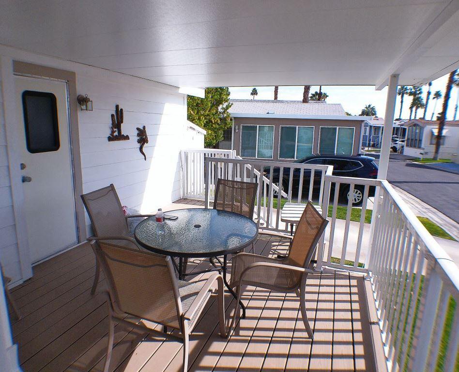 84136 Ave 44, Unit 150 Indio, CA 92203 - Photo 8 of 37 a view of a dining room with furniture and wooden floor