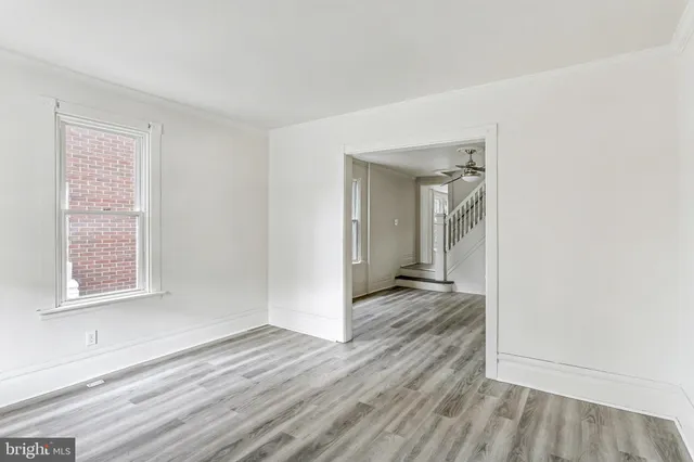 a yellow house with trees in front of it
