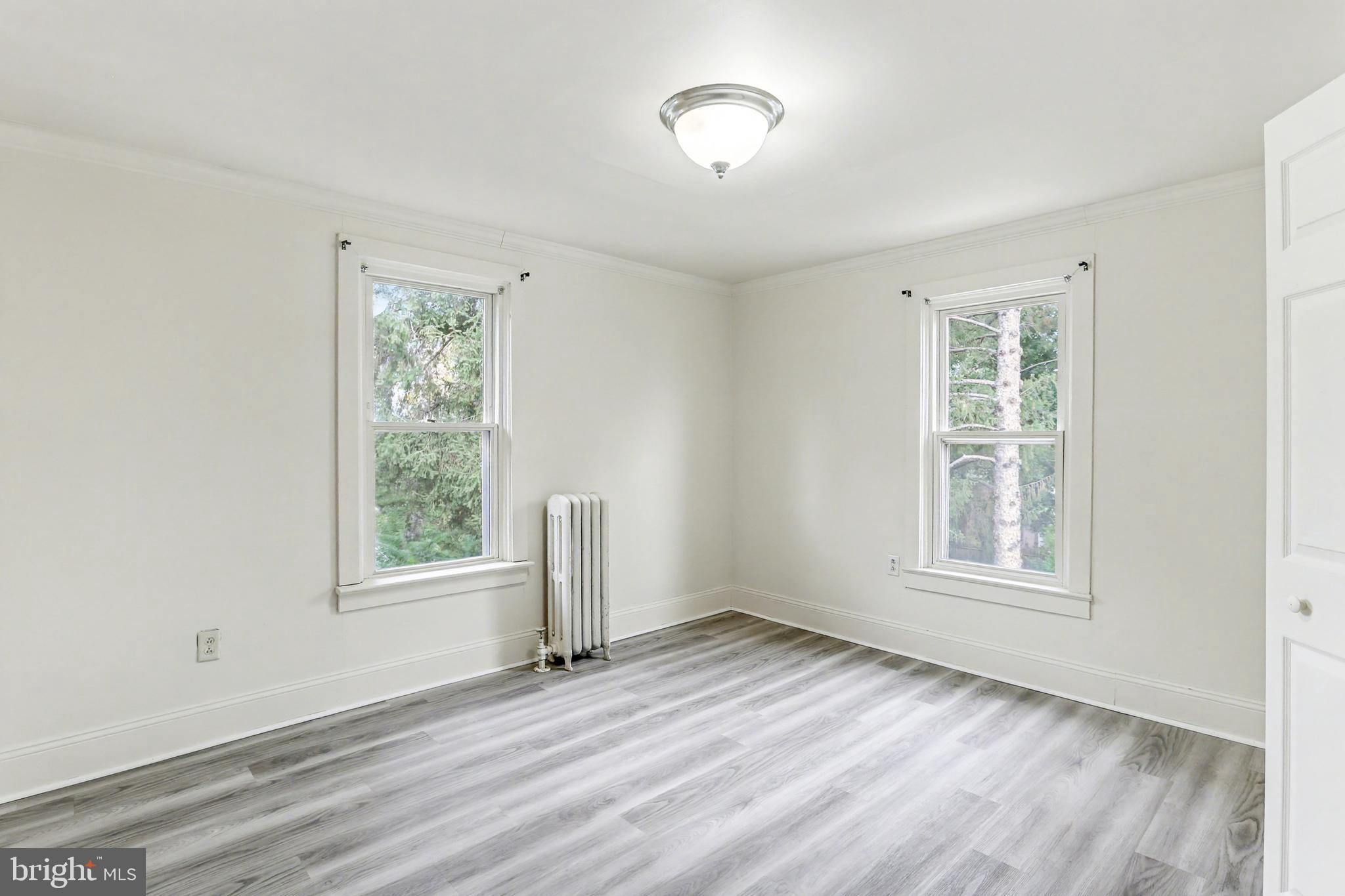 233 West Columbia Road Enola, PA 17025 - Photo 7 of 15 an empty room with wooden floor and windows
