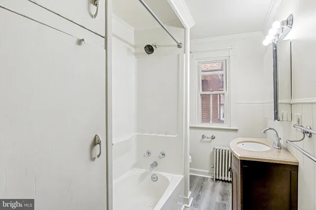 a bathroom with a sink a mirror and a bathtub
