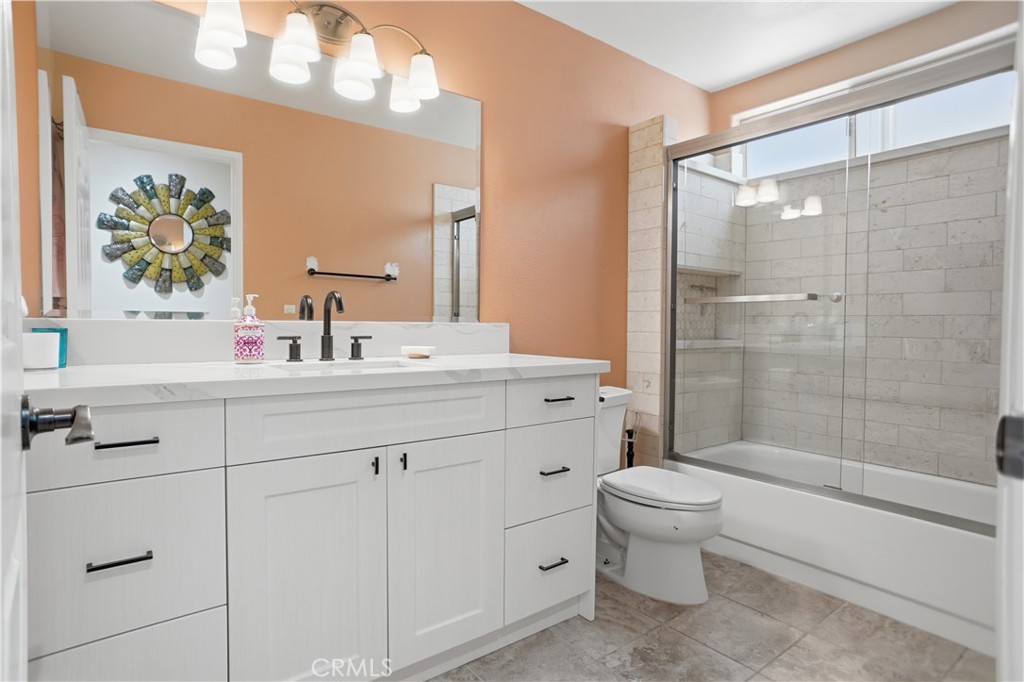 25550 Longfellow Place Stevenson Ranch, CA 91381 - Photo 13 of 30 a bathroom with a sink a toilet and shower