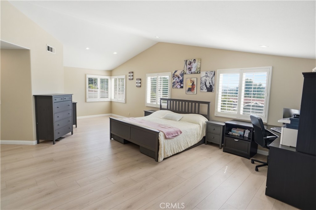 25550 Longfellow Place Stevenson Ranch, CA 91381 - Photo 16 of 30 a spacious bedroom with a bed and wooden floor