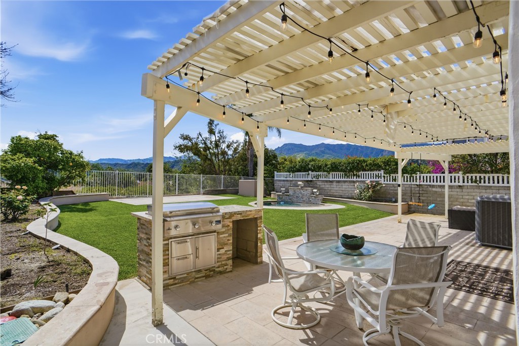 25550 Longfellow Place Stevenson Ranch, CA 91381 - Photo 25 of 30 a view of a patio with couches chairs and a big yard