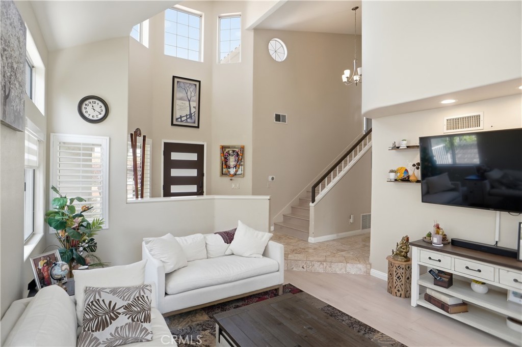 25550 Longfellow Place Stevenson Ranch, CA 91381 - Photo 3 of 30 a living room with furniture and a flat screen tv