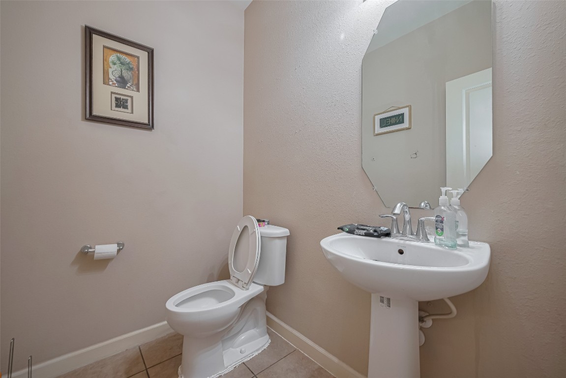 1703 Macclesby Lane Houston, TX 77049 - Photo 17 of 41 a bathroom with a toilet sink and mirror