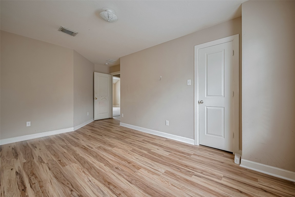 1703 Macclesby Lane Houston, TX 77049 - Photo 29 of 41 a view of empty room with wooden floor and fan