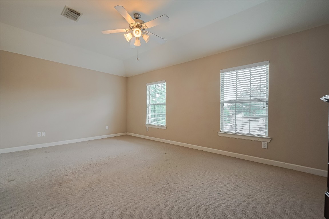 1703 Macclesby Lane Houston, TX 77049 - Photo 30 of 41 an empty room with a window and a fan
