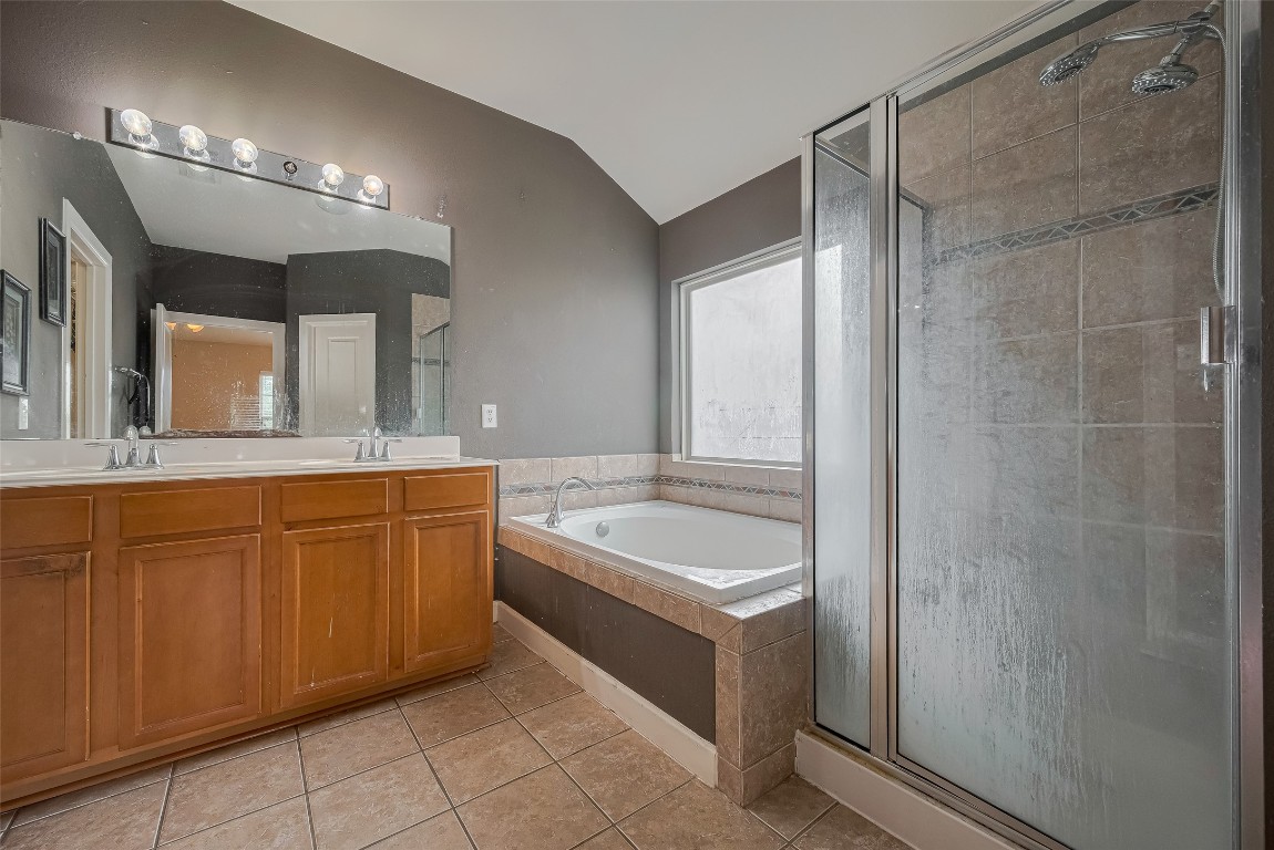 1703 Macclesby Lane Houston, TX 77049 - Photo 34 of 41 a spacious bathroom with a tub sink and mirror