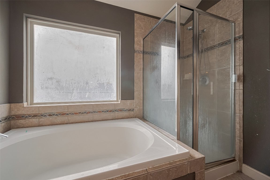1703 Macclesby Lane Houston, TX 77049 - Photo 36 of 41 a bathroom with a bathtub and a shower