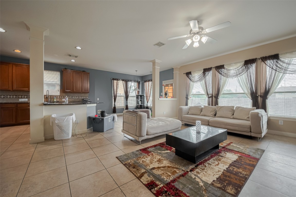 1703 Macclesby Lane Houston, TX 77049 - Photo 8 of 41 a living room with furniture and a chandelier