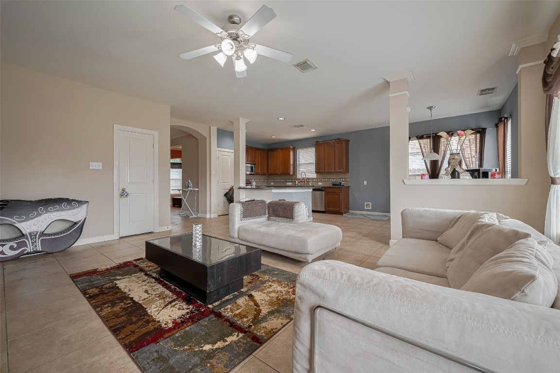 1703 Macclesby Lane Houston, TX 77049 - Photo 9 of 41 a living room with furniture and a chandelier