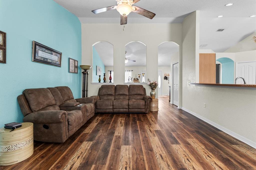 16038 Malden Road Weeki Wachee, FL 34614 - Photo 13 of 40 a living room with furniture and wooden floor
