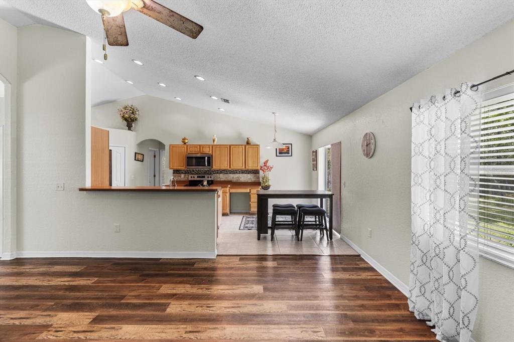 16038 Malden Road Weeki Wachee, FL 34614 - Photo 14 of 40 a view of kitchen area with stainless steel appliances furniture stove and refrigerator