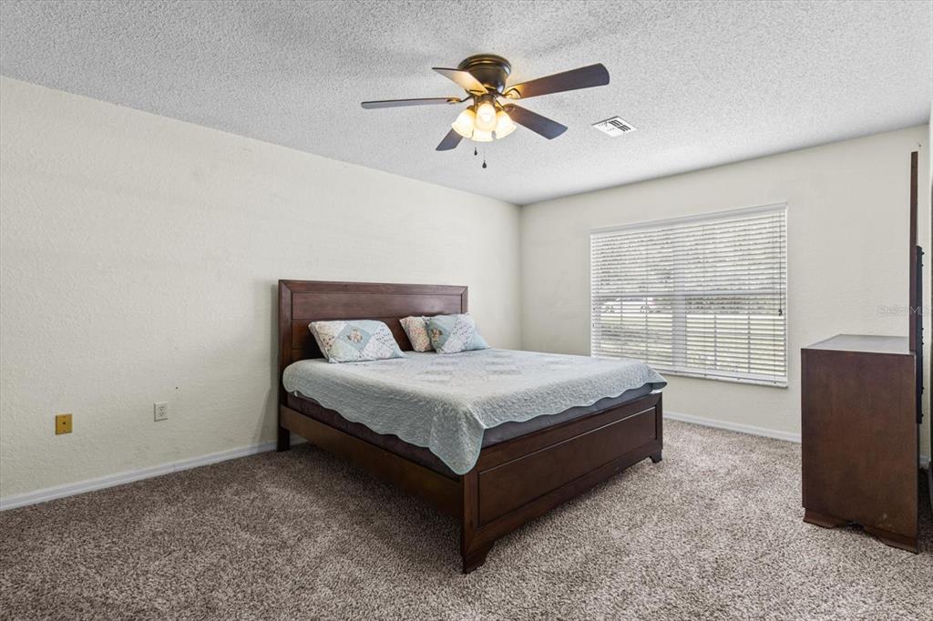 16038 Malden Road Weeki Wachee, FL 34614 - Photo 15 of 40 a bedroom with a bed and window