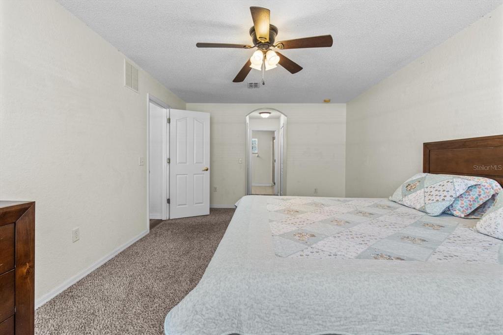 16038 Malden Road Weeki Wachee, FL 34614 - Photo 17 of 40 a bedroom with a bed and a chandelier